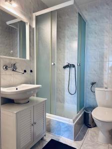 a bathroom with a sink and a shower and a toilet at SunRise Mielno in Mielno +81 photos