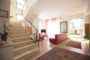 a hallway with stairs in a building with a rug at Hotel Brunella in Rimini