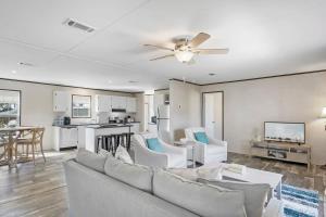 a living room with a couch and a ceiling fan at Canal Home Dock Walk to Beach Kayaks SUP Fishing in Saint Augustine