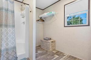 a bathroom with a shower and a window at Canal Home Dock Walk to Beach Kayaks SUP Fishing in Saint Augustine +40 photos