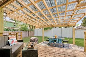 a patio with a wooden pergola with a table and chairs at Eclectic Beauty, Heart of Downtown St Aug in Saint Augustine