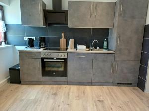 a kitchen with stainless steel cabinets and a sink at Ferienwohnung Krokus in Drebach