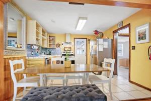 a kitchen and dining room with a table and chairs at Eclectic Beauty, Heart of Downtown St Aug in Saint Augustine