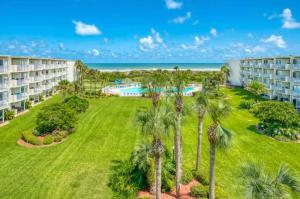 - une vue aérienne sur un complexe avec des palmiers et une piscine dans l'établissement Stunning Ocean Views, Huge Patio, Heated Pool and Amenities!, à Saint Augustine