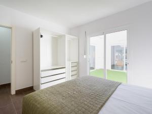 a white bedroom with a bed and a large window at Pasito Blanco Villas in Pasito Blanco +81 photos