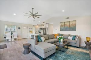 a living room with a couch and a table at Ocean Views Retreat! Renovated Apt with Beach Bikes! in Saint Augustine