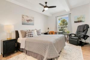 a bedroom with a bed and a ceiling fan at Park It At the Butterfield Garage, Historic Pre-Prohibition Style Apt in the Heart of Downtown in St. Augustine