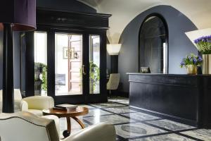 a living room with a table and chairs at Hotel Balestri - WTB Hotels in Florence