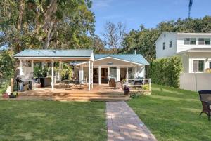 a home with a deck and a house at Charming Fishing Cabin Has It All, Full Dock and Summer Kitchen, Access to SUPs, Bikes, Beach Gear in Palm Coast