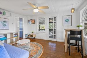 a living room with a couch and a ceiling fan at Marvelous Mermaid Bungalow, Dog-Friendly Upstairs Apt in Prime Vilano Beach in St. Augustine