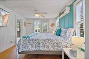 a bedroom with a bed and a ceiling fan at Marvelous Mermaid Bungalow, Dog-Friendly Upstairs Apt in Prime Vilano Beach in St. Augustine