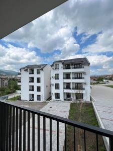 a view from the balcony of a white apartment building at Verde Apartman Sokobanja in Soko Banja