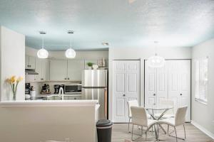 a kitchen with a table and chairs and a refrigerator at Uptown Gem The Castaway Cottage, Dog Friendly! in Saint Augustine
