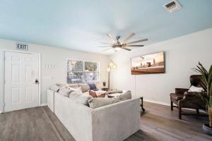 a living room with a couch and a ceiling fan at Uptown Gem The Castaway Cottage, Dog Friendly! in Saint Augustine