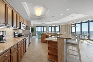 a large kitchen with a view of the ocean at Phoenix West II 1901 Wrap-Around Balcony in Orange Beach