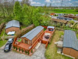 an aerial view of a house with a roof at Family Luxury York Cabin Retreat with hot tub in York