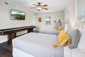 a bedroom with a white bed and a piano at Rave Reviews for Waterway Views Spa Comfy Beds Bring Your Boat in Saint Augustine