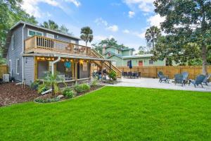 a house with a deck and a yard at Garden Views in Lincolnville Walk DT Dogs OK in Saint Augustine