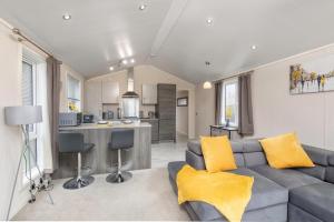 a living room with a couch and a kitchen at Family Luxury York Cabin Retreat with hot tub in York