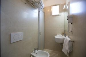 a bathroom with a sink and a toilet and a shower at Hotel Brunella in Rimini +36 photos