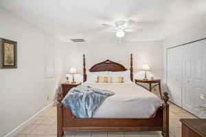 a bedroom with a bed and a ceiling fan at Dog Friendly Cottage Just North of Historic St Aug in Saint Augustine