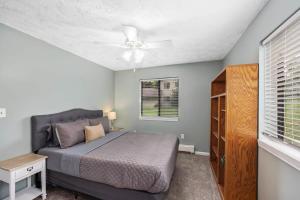 um quarto com uma cama e uma ventoinha de tecto em Family-friendly cottages by Lake Bella Vista em Rockford