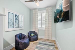 a living room with two chairs and a ceiling fan at Lincolnville Luxe Upscale Home in Heart of St Aug in Saint Augustine