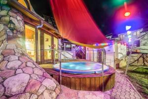 a hot tub in the middle of a building with lights at Hotel Piroska in Bük