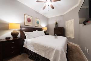 a bedroom with a bed and a ceiling fan at Phoenix West II 2307 Lazy River + Waterslide in Orange Beach