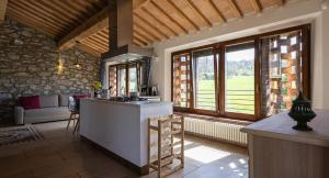 a kitchen with a counter in a room with windows at Ca'Novae - Tuscany Farmhouse in Montieri