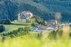 a large house on a hill in the mountains at Obergasserhof in Rodengo