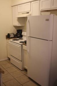 a kitchen with a white refrigerator and a stove at 1 bedroom apartment within sight of Fort. Sill in Lawton