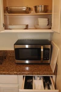a microwave sitting on a counter in a kitchen at 1 bedroom apartment within sight of Fort. Sill in Lawton