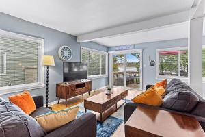 a living room with a couch and a tv at 4 BR 2 BA Peaceful Getaway Year Round on Park Lake in Bath