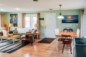 un soggiorno con un divano e un tavolo di Beach Club of Oscoda - The Lakeshore Cottage a Oscoda Altre 17 foto