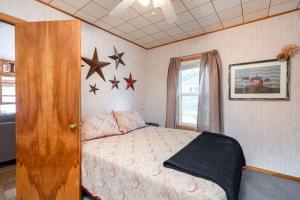 a bedroom with a bed and stars on the wall at Priscilla's Place on Big Pine Island Lake in Belding
