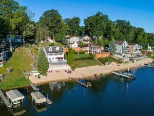 an aerial view of a house on the shore of a body of water at Priscilla's Place on Big Pine Island Lake in Belding