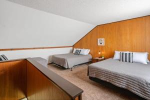 a hotel room with two beds and a desk at Fife Lake Lodge Multi-level Suite with Lake Views in Fife Lake