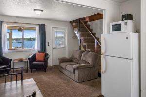 a living room with a couch and a refrigerator at Fife Lake Lodge Multi-level Suite with Lake Views in Fife Lake
