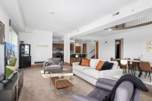 a living room with couches and a dining room at Extravagant 3 Level Penthouse at The Grand Castle in Grandville