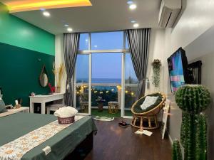 a bedroom with a bed and a large window at Căn hộ Ocean Vista in Ấp Ngọc Hải