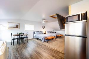 a kitchen and living room with a bed and a refrigerator at Fife Lake Lodge 2 Lakeside Apartment Units in One in Fife Lake