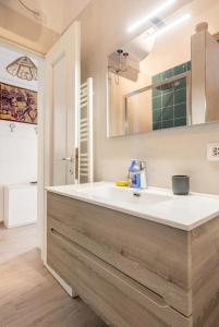 a bathroom with a white sink and a mirror at [Seaside Apt] Private Parking and near the beach in Viareggio