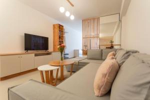 a living room with a couch and a table at Museo Paseo de la Cisterna, UF 431 in Buenos Aires