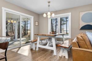 a dining room with a table and a window at Long Lake Dream Dogs Welcome in Traverse City