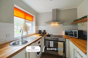 a kitchen with a sink and a stove at Tritton Lodge, 2 Bedroom House By Broad Meadow Stays Short Lets and Serviced Accommodation Lincoln With Free Parking in Lincoln