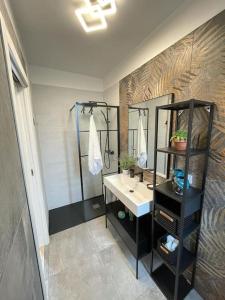 a bathroom with a sink and a mirror at Luxury home A Casuzza con Jacuzzi vicina al mare in Casteldaccia +10 photos