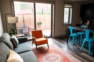 a living room with a couch and a table and chairs at Modern State Unit 2 in Traverse City