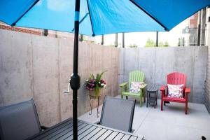 a table with chairs and an umbrella on a patio at Modern State Unit 1 in Traverse City