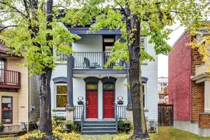 a house with a red door and two trees at Heritage home near Byward Market downtown Ottawa in Ottawa